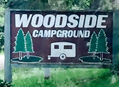 Color photo of sign at entrance of Woodside Campground.
