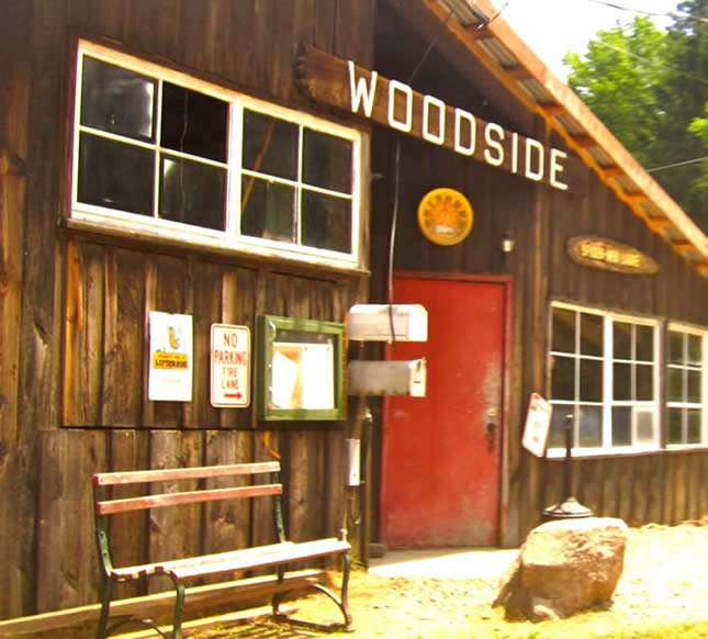 Color photo of a large building made of wood. 